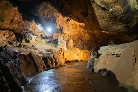 Uneven brown cave walls with lighting insideの写真素材