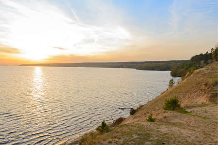 Autumn landscape with a sandy riverbank at sunsetの写真素材