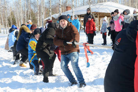 March 13, 2021: Men play tug of war on a winter day. Cheboksary. Russia.のeditorial素材