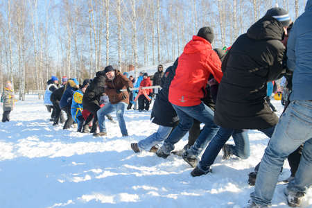 March 13, 2021: Men play tug of war on a winter day. Cheboksary. Russia.のeditorial素材