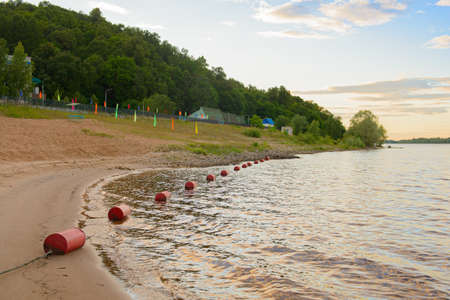 The river bank with a children's health camp on a summer eveningの写真素材