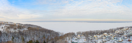 Panoramic winter landscape with wide Volga river and banks top viewの写真素材
