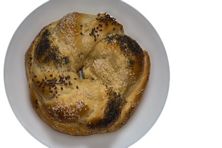 Kalach. Traditional Ukrainian handmade pastry on a white dish