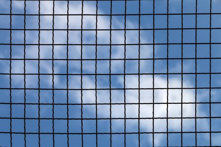 Lattice fence on the background blue sky.の写真素材
