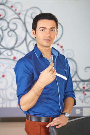 Hair salon  Portrait of hairdresser with cutthroat in his hand 