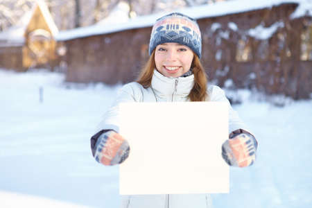 Young beautiful woman with blank banner  Winter の写真素材