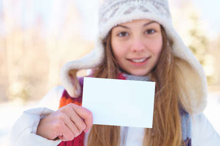 Young beautiful girl with blank banner  Winter 