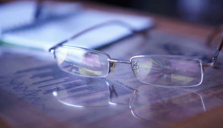 Glasses on the charts  Pie chart on reflection の写真素材