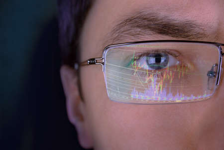Financier in glasses looking at monitor. Financier in glasses looking at monitor.