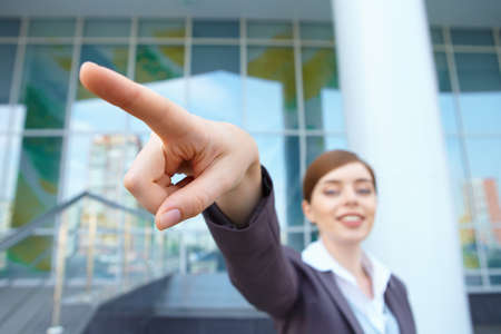 Businesswoman shows right direction.の写真素材