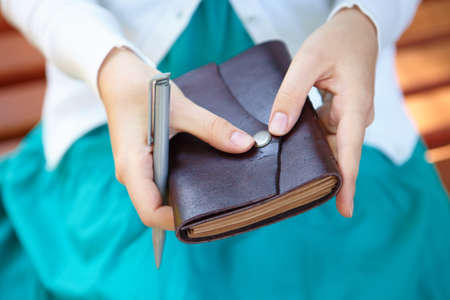 Young woman holds notebook in hands.の写真素材