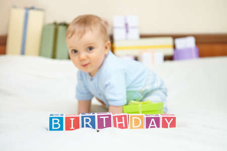Portrait of baby boy on bed. Birthday concept.の写真素材