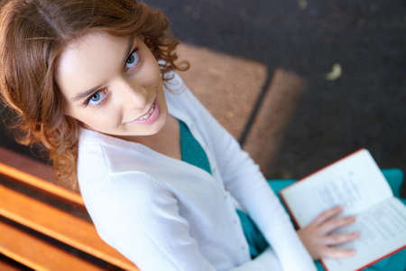 Young woman reads book.