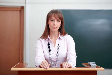 Back to school. Portrait of teacher at tribune.の写真素材