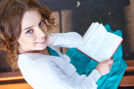 Young woman reads book.
