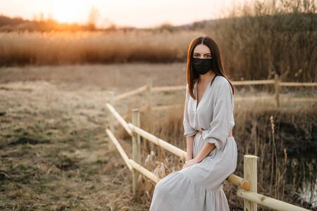 Woman in a protective mask while walkingの写真素材
