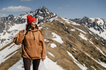 young girl in the mountains with a backpack. Active rest in one with natureの写真素材