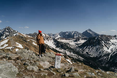 young girl in the mountains with a backpack. Active rest in one with natureの写真素材