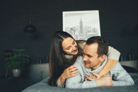 Happy couple smiling in bed. Happy family. High quality photo