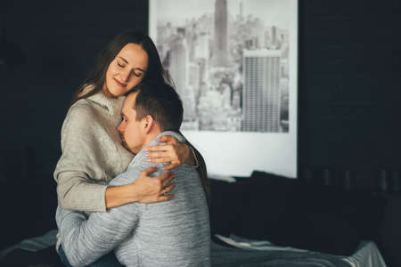 Young wife smiles and hugs her husband. Hugs. Cancer and family support concept. High quality photoの写真素材