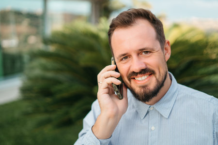 Businessman talking on phone outdoor. Communication. Mobile phone, smartphone. Mobile connection. High quality photoの写真素材