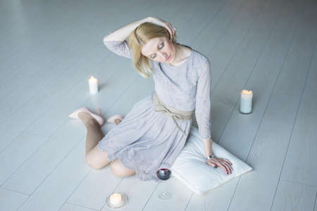 blonde with a glass of wineの写真素材