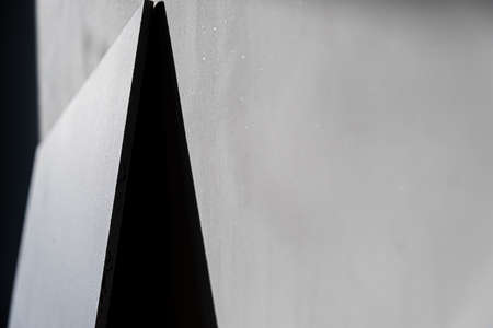 black shadow in the form of a triangle on a concrete wall. background, abstraction. Gray.の写真素材