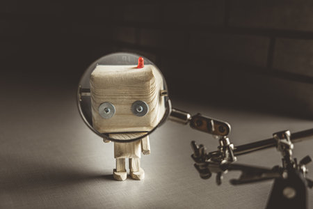 wooden robot android stands on a table under a magnifying glass. metal clamps with a magnifying...