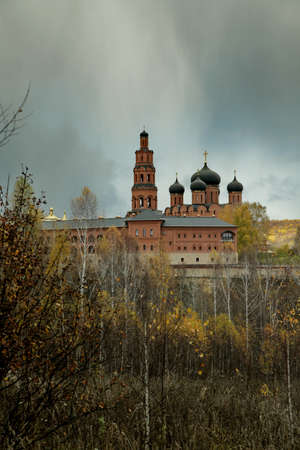 Bright light over Orthodox monastery in the dark sky