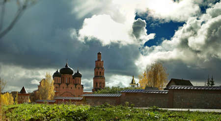 Bright contrasting sky over Orthodox monastery in autumn
