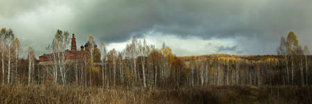 Cloudy sky above the birch grove and the Orthodox monasteryの写真素材