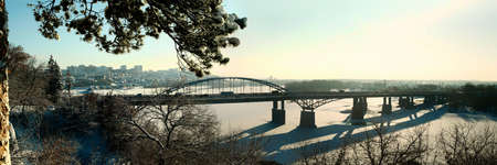 City bridge over the frozen river in winterの写真素材