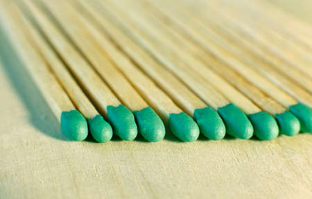 Matchsticks with green tips on a birch board macro close upの写真素材