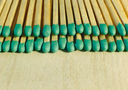 Matchsticks with green tips on a birch board macro close upの写真素材