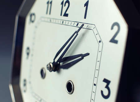 Focus on tips of hand with strong depth of field on an antique watchの写真素材