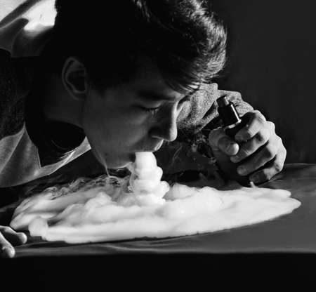 Vape trick waterfall in performance of vaper on dark backgroundの写真素材