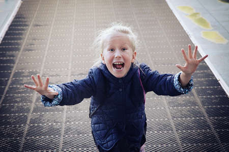 Joyful and enthusiastic girl child runs towardsの写真素材