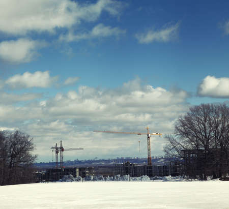 Panorama of construction site with building cranes against the background of cityscapeの写真素材