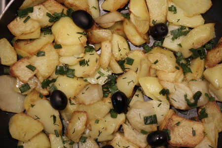 fried potatoes with olivesの写真素材
