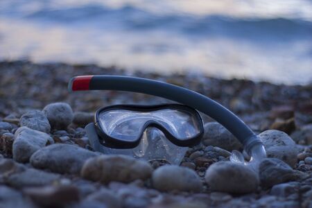 Glasses and tube on the shore of the beachの写真素材
