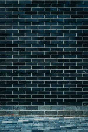 Modern black colored brick pattern wall texture grunge backgroundの写真素材
