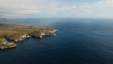 Aerial view of Rocky coast with high cliffs, sea surf with breaking waves on the coast, Nusa Penida,...