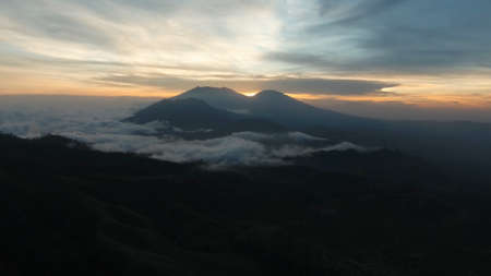 Beautiful sunset in the mountains on Jawa island, Indonesia. Aerial view of mountains landscape...