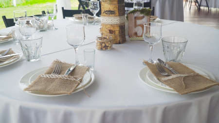 Banquet decorated table, with cutlery. Serving of a festive table, plate, napkin, knife, fork. Table...