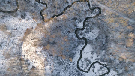 Aerial view Winter landscape countryside, forest, river, snow. River, forest, trees covered with frost snowの写真素材