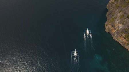Aerial view of motor boat in sea. Aerial image of motorboat floating in a turquoise blue sea water....