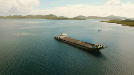 Cargo and passenger port with barges and cargo ships on tropical island. Aerial view:passenger ferry...