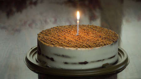 Birthday cake with colorful burning candle in dark. Cake: Birthday Cake With candle For Any Birthday.の写真素材