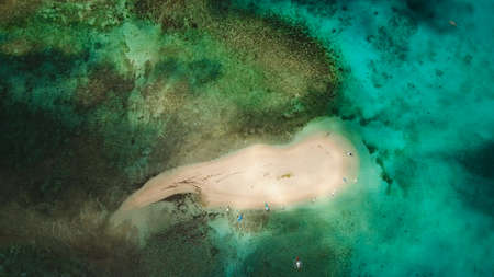 Aerial view of beautiful sand tropical island with white sand beach and tourists. White sand island....