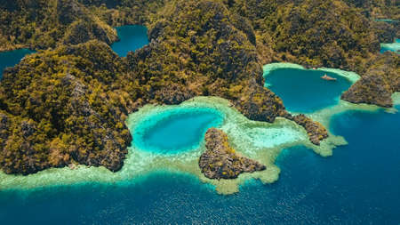 Aerial view: Mountain Barracuda lake, on tropical island, Lagoon with blue, azure water. Lake in the mountains covered with tropical forest on the island Coron, Palawan, Philippines.の写真素材